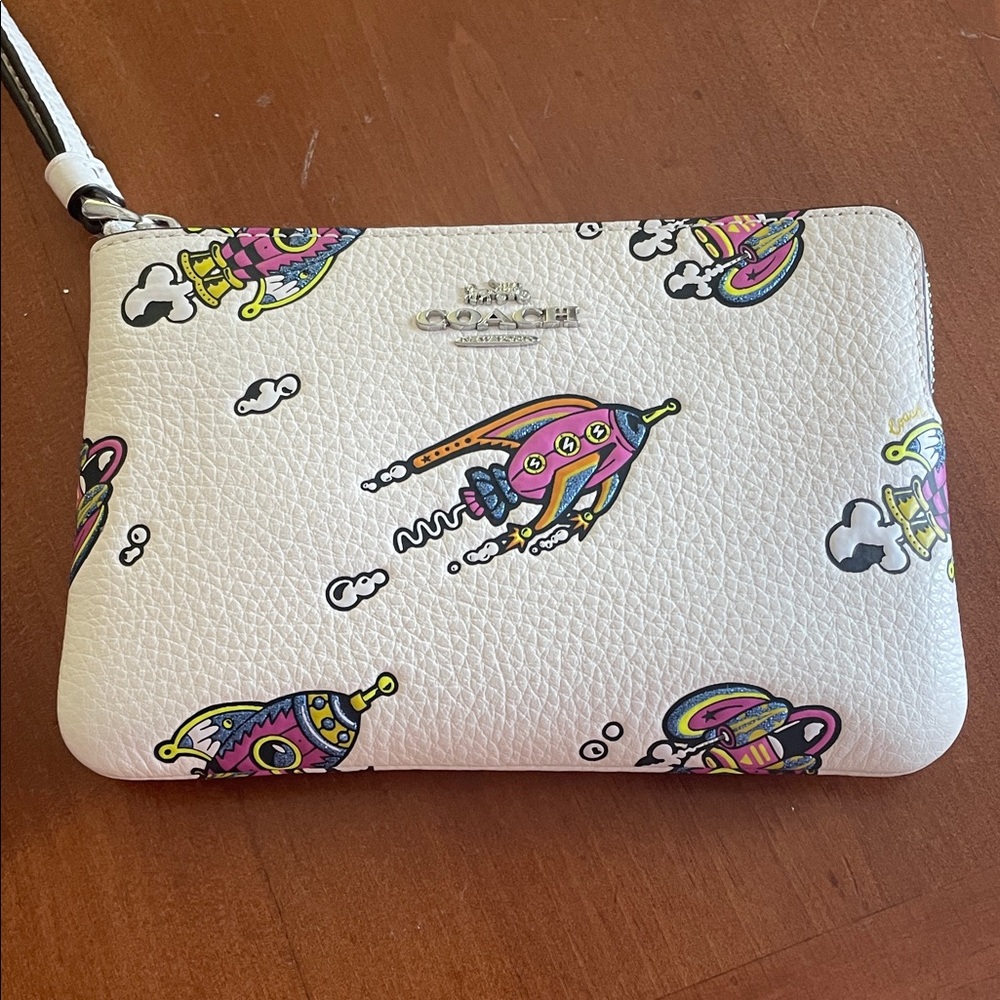 Coach Cream Wristlet with Vibrant Rocket Design